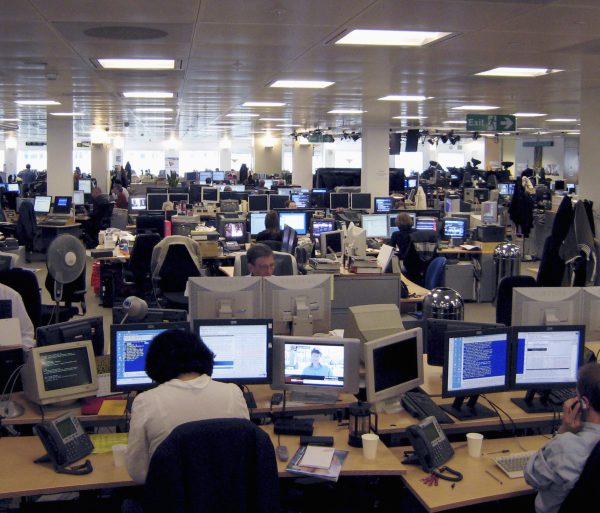Employees work in the Reuters newsroom in the Canary Wharf district of London May 4 2007. News and financial data provider Reuters said it had received a takeover approach from an unidentified bidder, sending its shares up almost a third, with Canadian publisher Thomson widely touted as the suitor.  REUTERS/Simon Newman (BRITAIN) - GM1DVELXCCAA